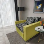 Fábia ágyneműtartós fotelágy őszi levélzöld szövet