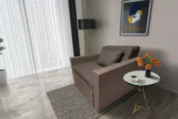 Mama ágyneműtartós fotelágy pasztell taupe mély földszürke színben